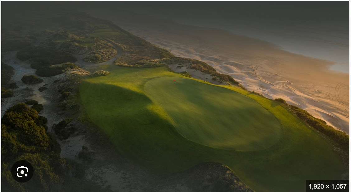 Aerial view of a links golf course at golden hour